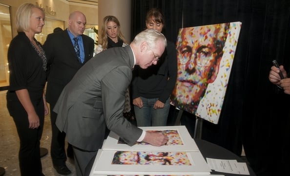 Gunn signs prints of his portrait.