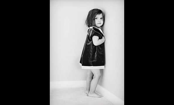 "Girl in the Corner".  When the photographer's daughter Katherine got a purple dress from her great-aunt as a gift, she fell in love with it and agreed to pose in it.  "I pictured the photograph with Katherine's back against the wall," Saeed says.  "When 