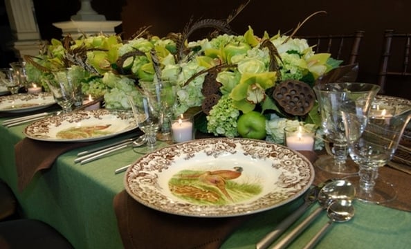 Large and mini hydrangeas, cymbidium orchids, jade roses, Granny Smith apples, limes, dried lotus pods, and pheasant feathers.