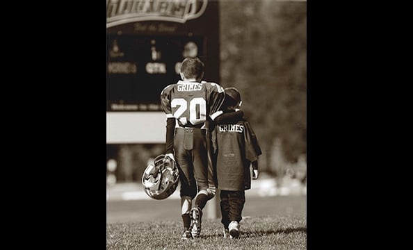 "Brothers in Arms" depicts Little Leaguers Rocky, eight, and AJ, five.  The photo was submitted by their father, James Grimes of Chesapeake Beach, who'd asked his friend John Marshall to photograph the boys at the last game of the season.  Says Grimes: "T