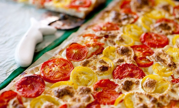 At G Street Food in downtown DC, bread guru Mark Furstenberg crafts airy Roman-style squares of pizza topped with tomatoes.