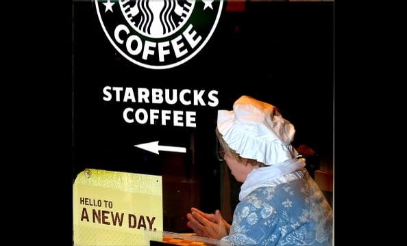 The juxtaposition of a 21st century Starbucks and an 18th century woman is clear—but this is what happens when tour guides take coffee breaks. 