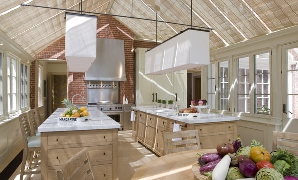 Surrounded by windows, the kitchen is pleasant in all kinds of weather. During thunderstorms, the homeowners open the shades and watch the lightning. 