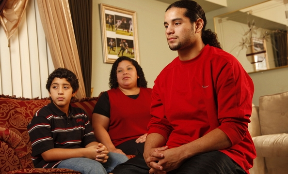 Photos of Chris Ventura playing football hang in his family’s apartment. His mother, Ana, was born in El Salvador and was diagnosed with a brain tumor when Chris was eight. Chris helps his mom look after his younger brother, Carlos.