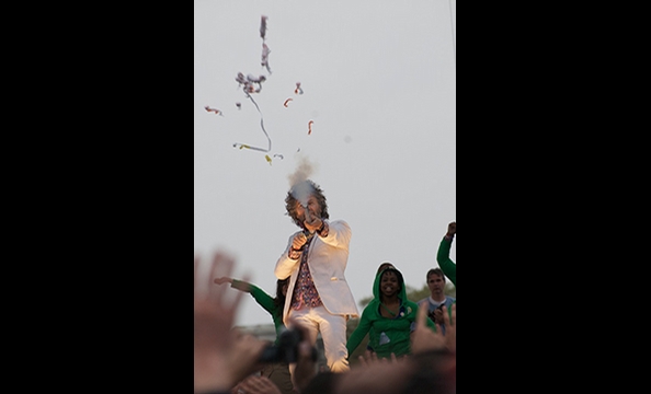 Front-man Wayne Coyne sends streamers into last year's Earth Day concert crowd.  