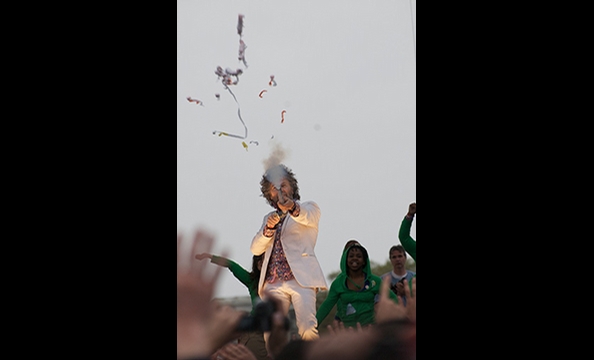 Front-man Wayne Coyne sends streamers into last year's Earth Day concert crowd.