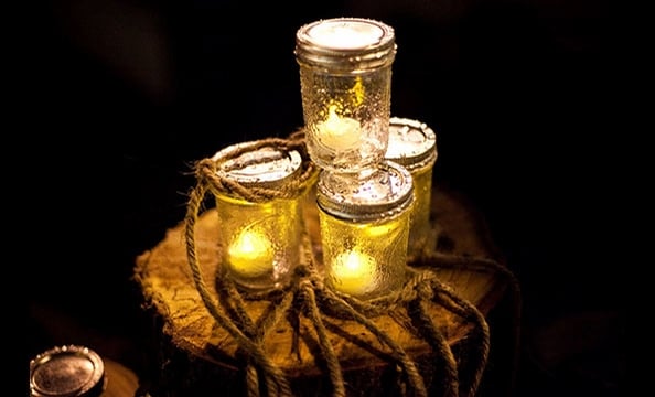 Recycled glass jars—each filled with a single LED light—prepared guests for a hyggelit evening.   