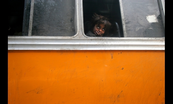 The photographer shot this haunting photo while sitting in a traffic jam in New Delhi, India. He writes: "She seemed so deep in thought, oblivious to the loud, chaotic scene around her."