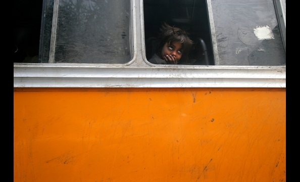 The photographer shot this haunting photo while sitting in a traffic jam in New Delhi, India. He writes: "She seemed so deep in thought, oblivious to the loud, chaotic scene around her." 