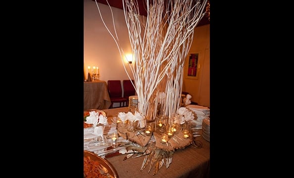 Chef Trina Hahnemann surrounded these winter tree branches with a menu of baked cod, pig jaw and onion jam, apple compote, and  kransekage—a traditional Danish marzipan ring cake— at the viewing party.  