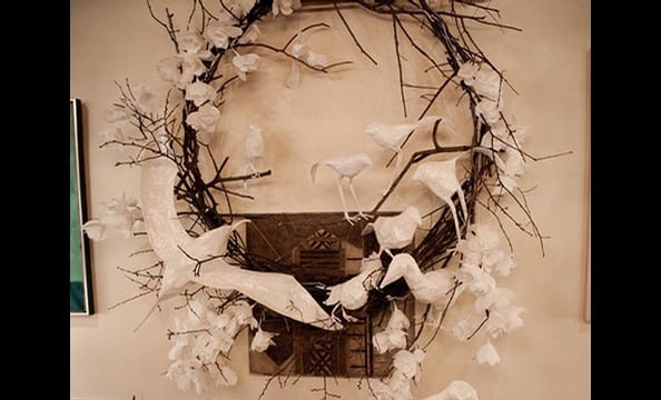 The artists collected stray sticks in a tree removal lot to make the base frame of this wreath, which extended over four feet in diameter. Paper-mâchéd crows and other forests birds—all representing endangered species—sit on the branches.