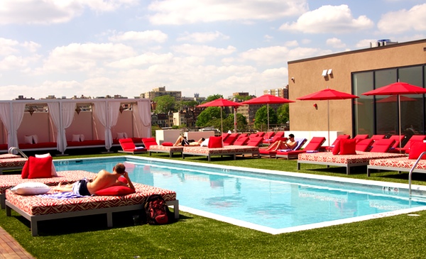 The pool is surrounded by synthetic grass.