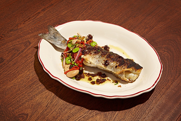 A Mediterranean-inspired dish of grilled loupe de mer with black olive tapenade and a salad of roasted red peppers and gigante beans. Photograph by Jeff Elkins. le diplomate