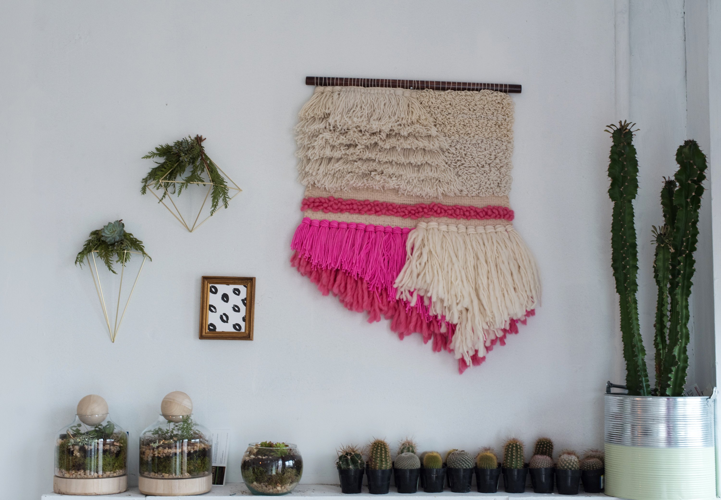 A Linny wall hanging adds a bolt of color above Simmons' cactus collection.