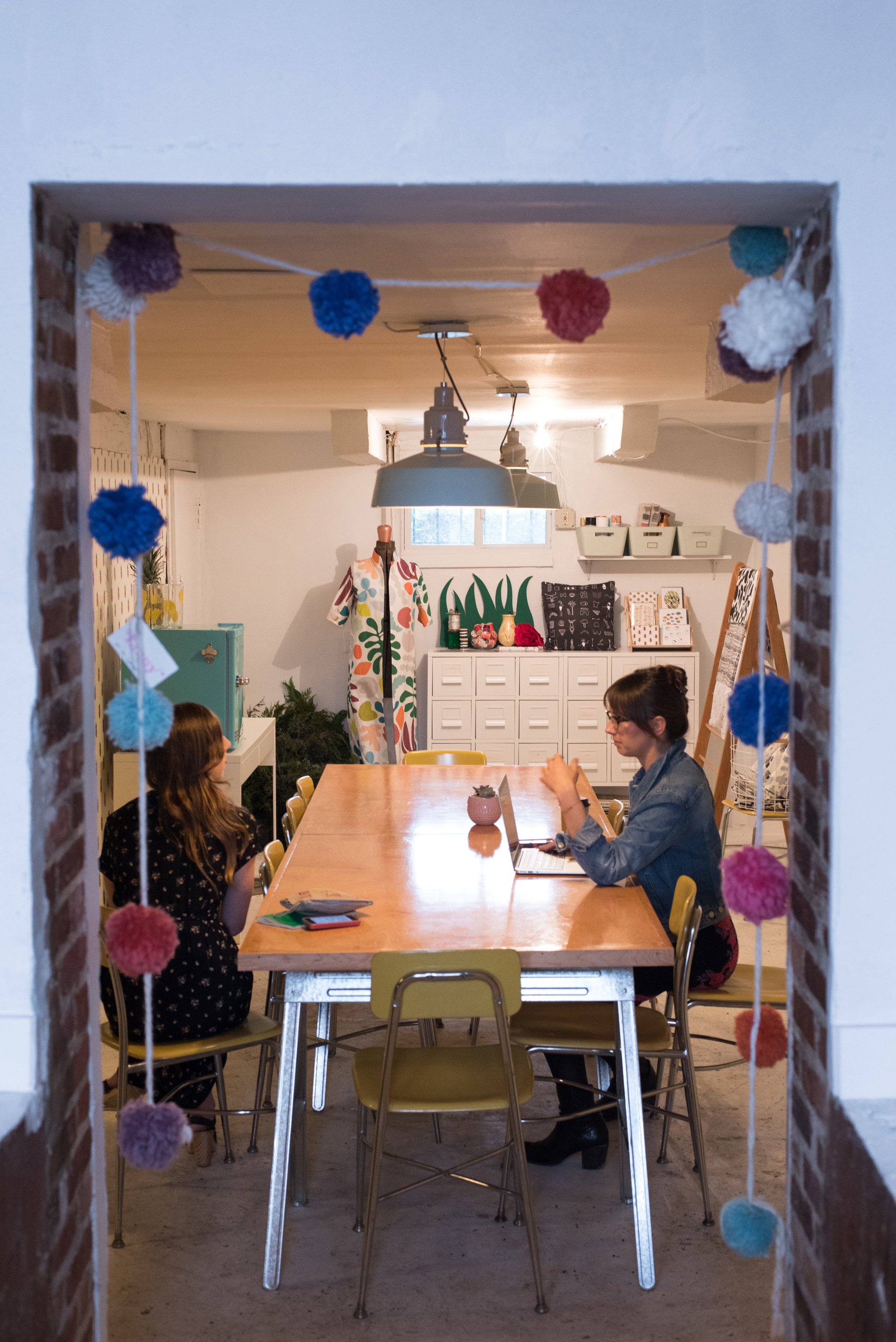 Giffin and Simmons work, and chat, at the workshop table in The Lemon Bowl's back room.