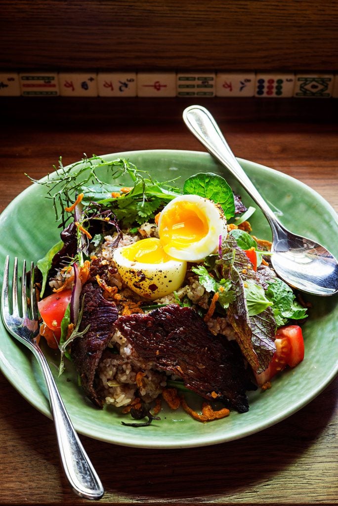 Dried beef with fresh herbs, garlicky rice, and a coddled egg. Photograph by Scott Suchman.