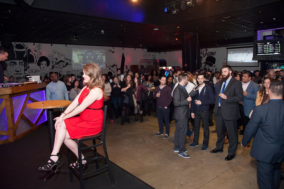 Contestant Bridget Dougherty listens as guests compete to win a date with her. 