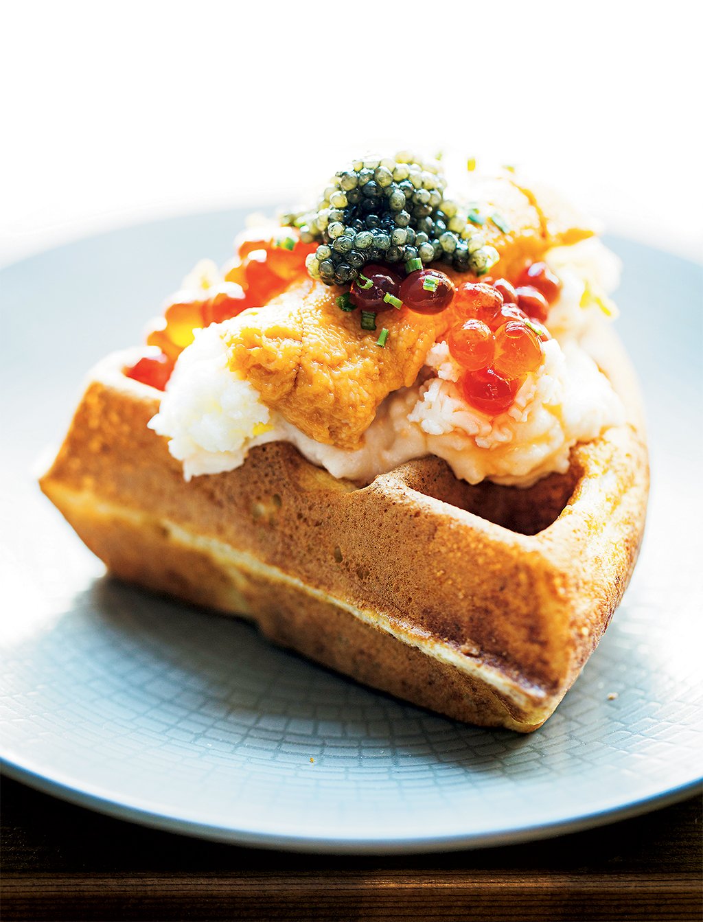 Inside our March 2016 issue: Jonah Kim brings a fine-dining background to Yona in Ballston. Exhibit A: his waffle laden with sea urchin and salmon roe. Photograph by Scott Suchman.
