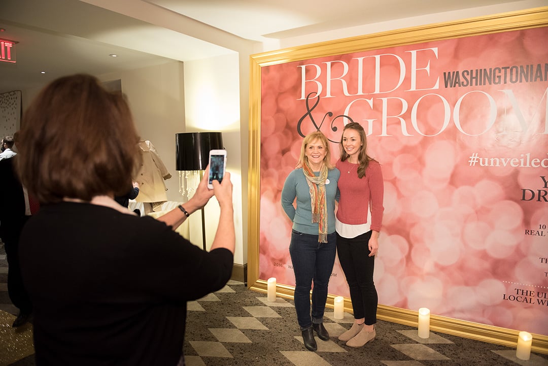 Attendees posed in front of the faux Washingtonian Bride & Groom cover created by Revolution Events.