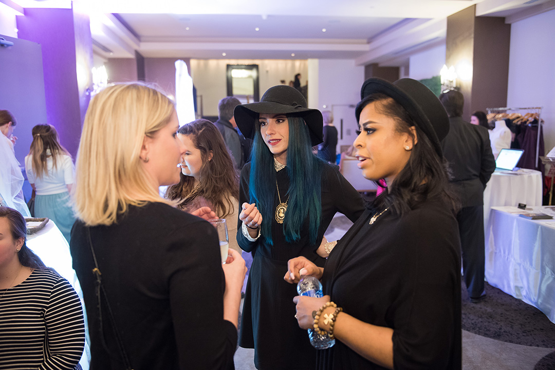 Ryan Ibrahim and Marquia Kinard of Blend Makeup Artistry converse with a guest at the showcase. 