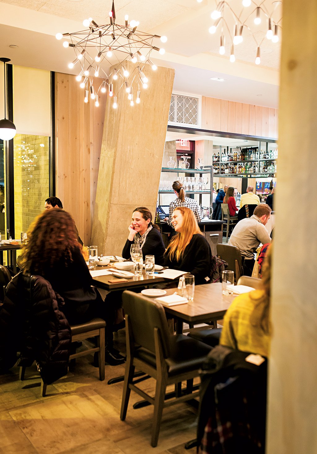 restaurantreview_convivial_diningroom - Washingtonian At Convivial in Shaw, Washington, DC, diners can share plates of scallop boudin blanc with snow peas and trout roe (opposite left) or pickled rockfish with green papaya and winter radish. Photograph by Scott Suchman.