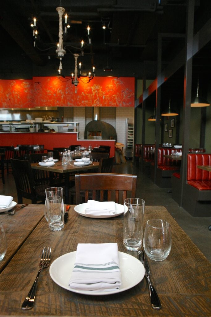 A view of the new restaurant, Alta Strada - Washingtonian Schlow's wife, artist Adrienne Schlow, contributes to the decoration, like with wall paintings above the open kitchen.
