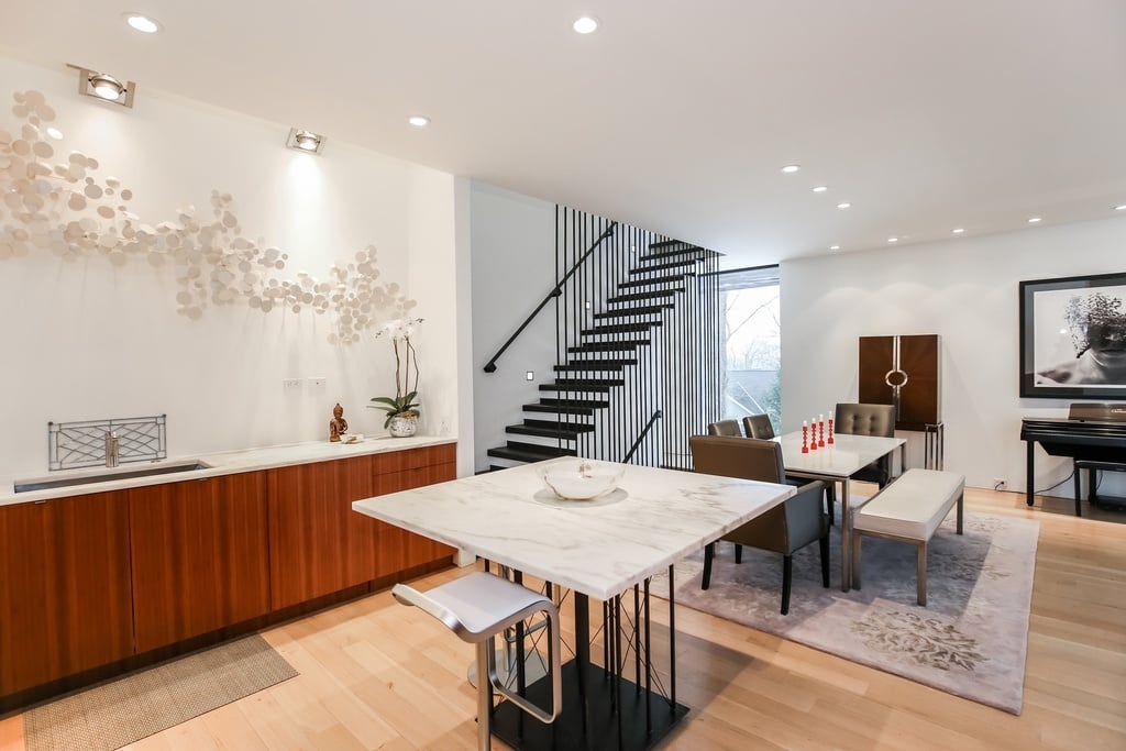 A chef's kitchen and hand-forged staircase are among the homes promising features.