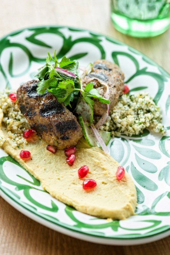 Look to the "souvlaki" section of the menu for grilled meats, such as this bifteki (ground beef) with tabouleh. 