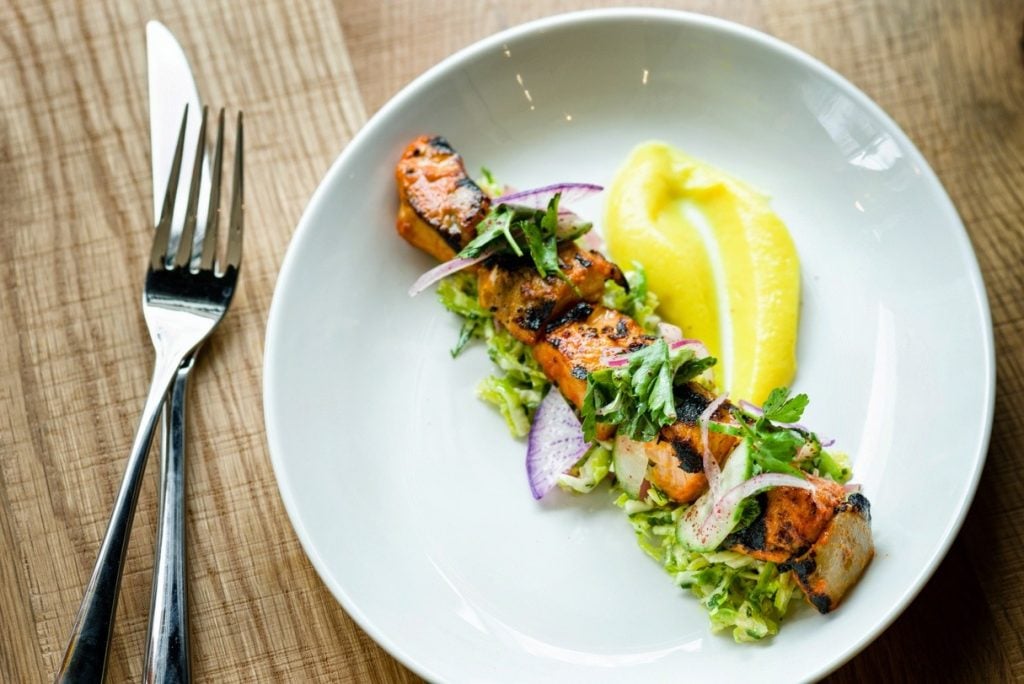 Seafood mezze include options like this spiced salmon kabob with cauliflower puree.