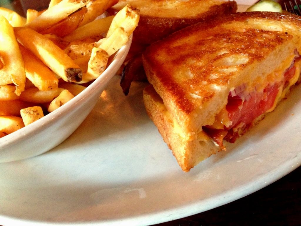 Stoney's "super grilled cheese" is just that, stuffed with bacon, tomato, and onion. Photograph via Flickr user Joe Flood