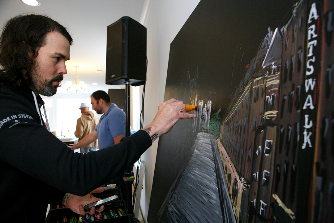 Patrick Owens creates an immaculate chalk drawing of nearby Monroe Street Market. 