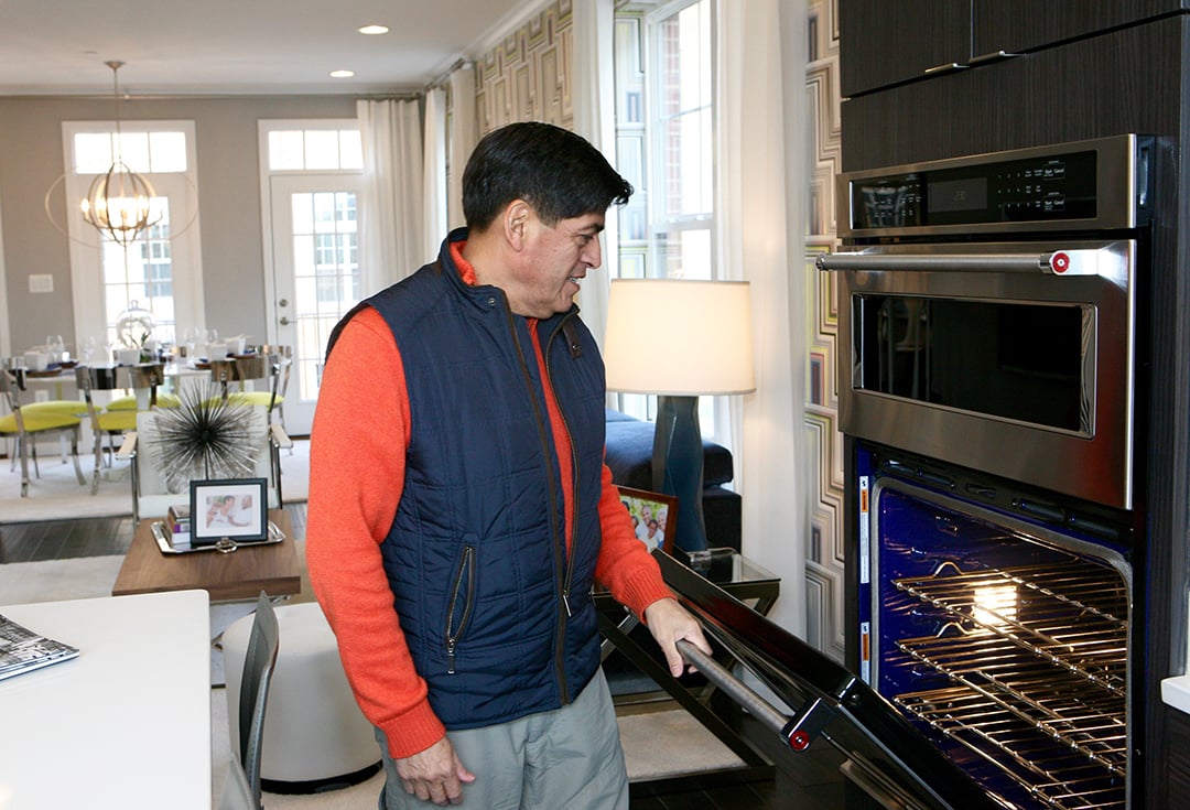 Holger Sarrono admires the new oven in the model home. 