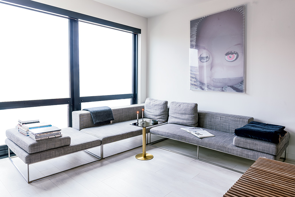 Julie-Bjarnhoff-apartment - Washingtonian rental; Bright white walls, light floors, and simple furniture take full advantage of the space's giant windows and natural light. Photograph by Andrew Propp.