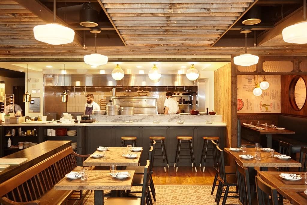 Like at the Red Hen, the open kitchen is a focal point of the dining room. 