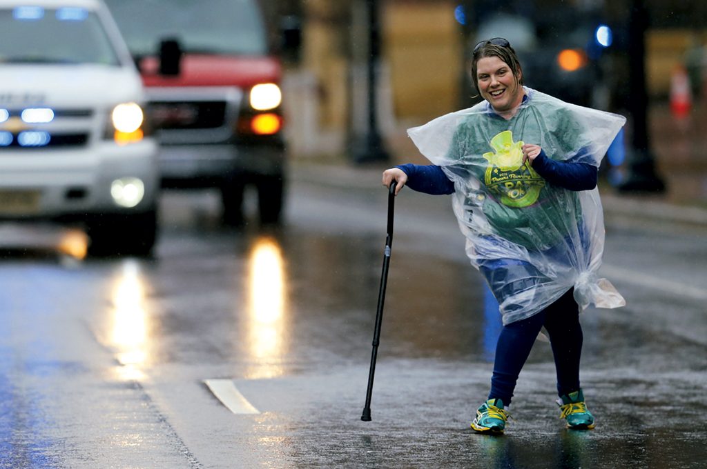 Jamie Watts, escorted by a police car, in Arlington's Four Courts Four Miler. Photograph by Brian W. Knight/Swim Bike Run Photo. (July 2016/Chesapeake Bay)