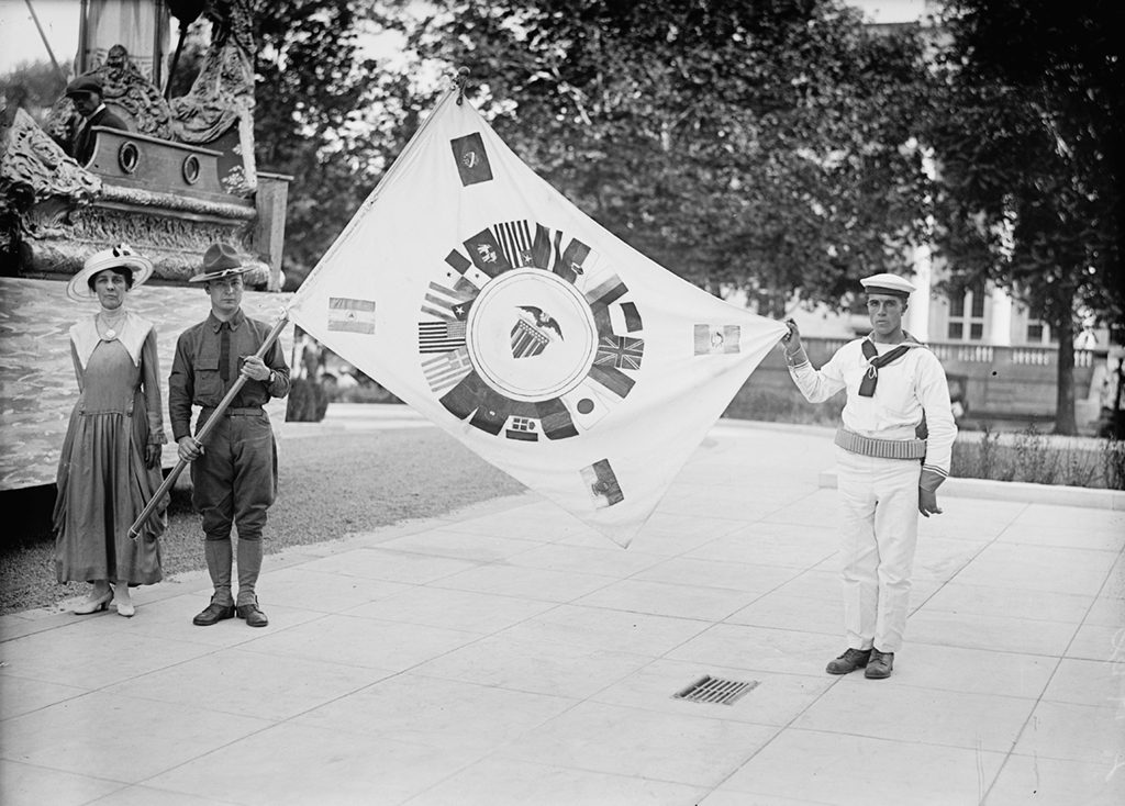 Mrs. J. Wilmuth Gary standing next to an allied flag. Photograph via Harris & Ewing Collection (Library of Congress). 