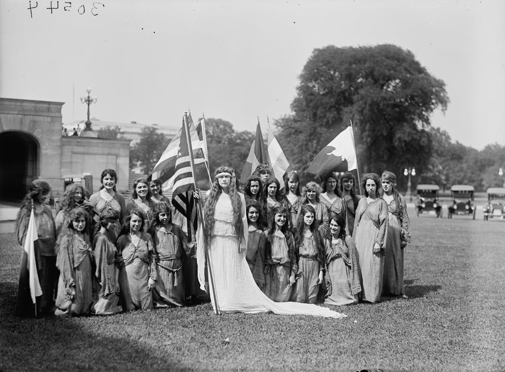 A woman in a Columbia costume with a group of dancers. Photograph via Harris & Ewing Collection (Library of Congress). 
