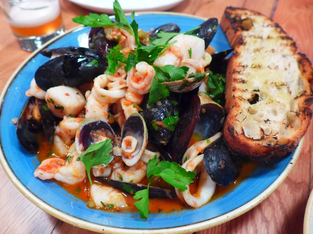 Seafood plays a large role on the menu, like this seafood stew with grilled bread. Photograph by Anna Spiegel