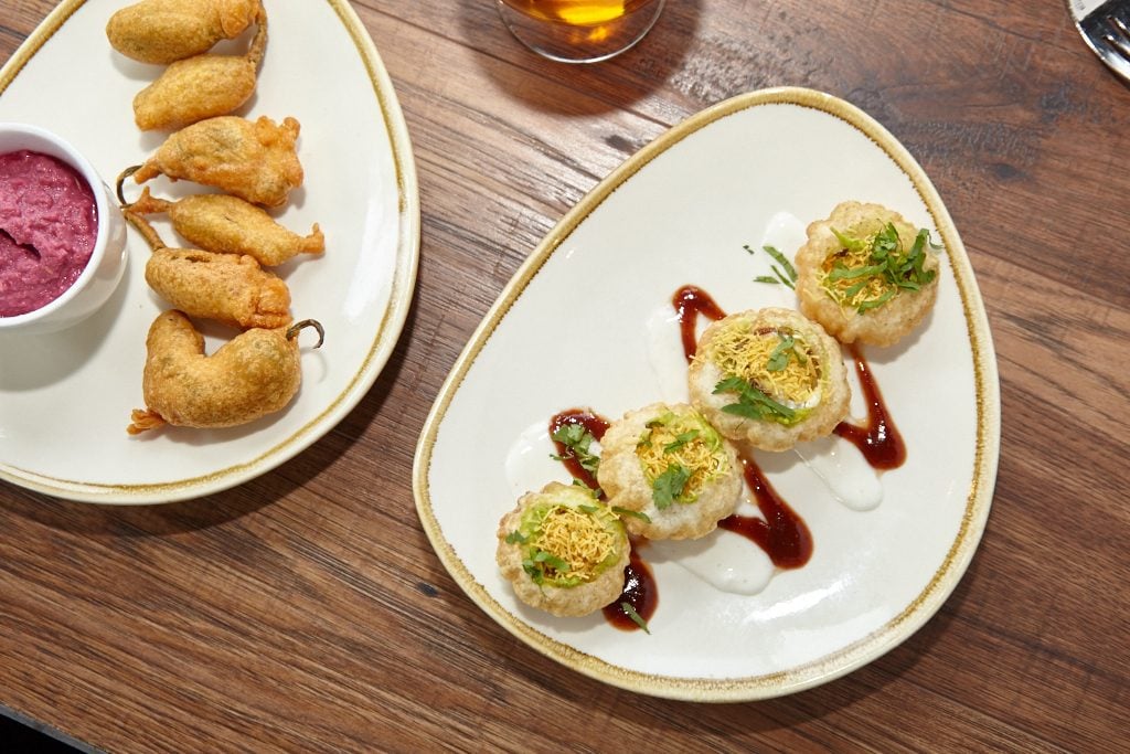 Diners can start with savory chaat, or snacks, like these avocado-stuffed golgappa with yoghurt and tamarind chutney.
