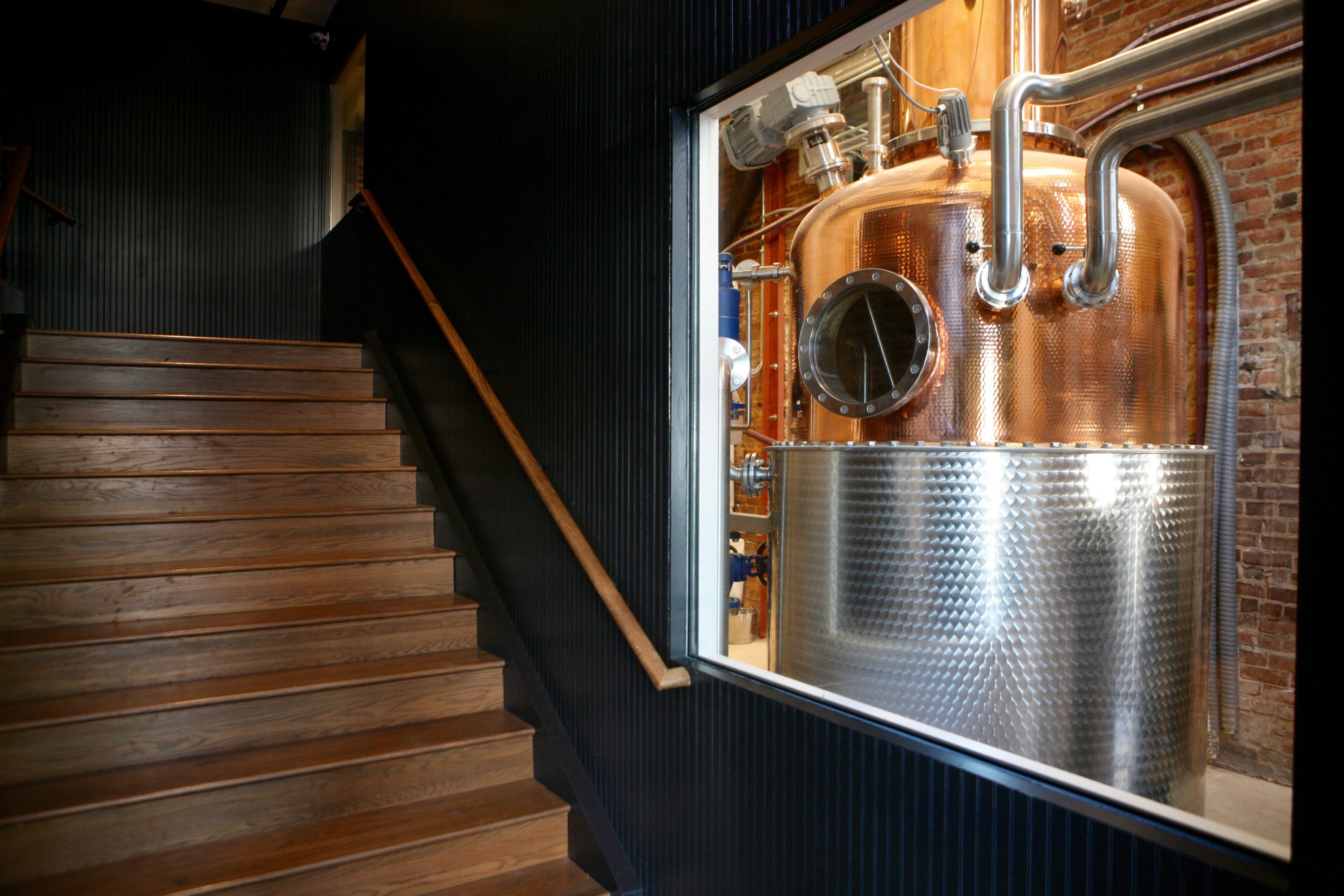 Guests glimpse the distilling equipment as soon as they walk in the door. Photography by Evy Mages. 