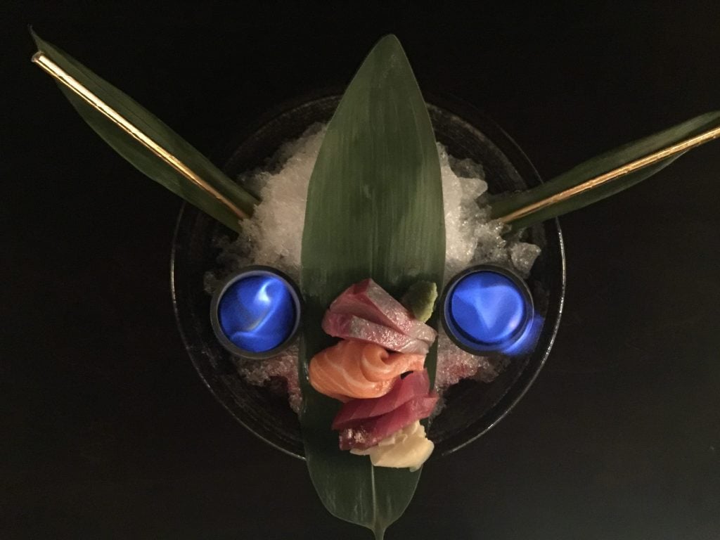 The Wandering Samurai cocktail, made with sak, rum, and yuzu, and garnished with sashimi. 