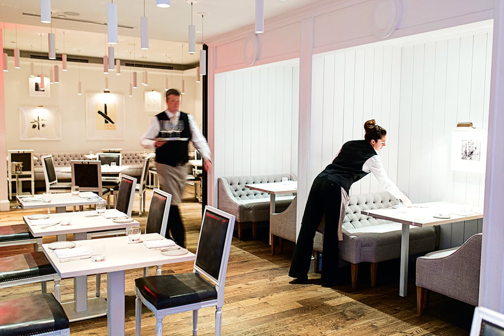 kinship-restaurant-review-eric-ziebold-dining-room-design-darryl-carter - Washingtonian Kinship staffers prepare the Darryl Carter-designed dining room for service.