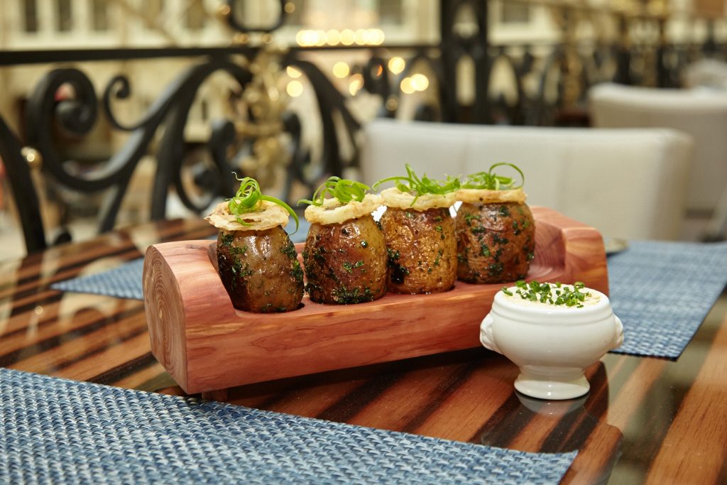 Burke's "couch potatoes" i.e. baked potatoes resting on a locally-carved cedar bench. 