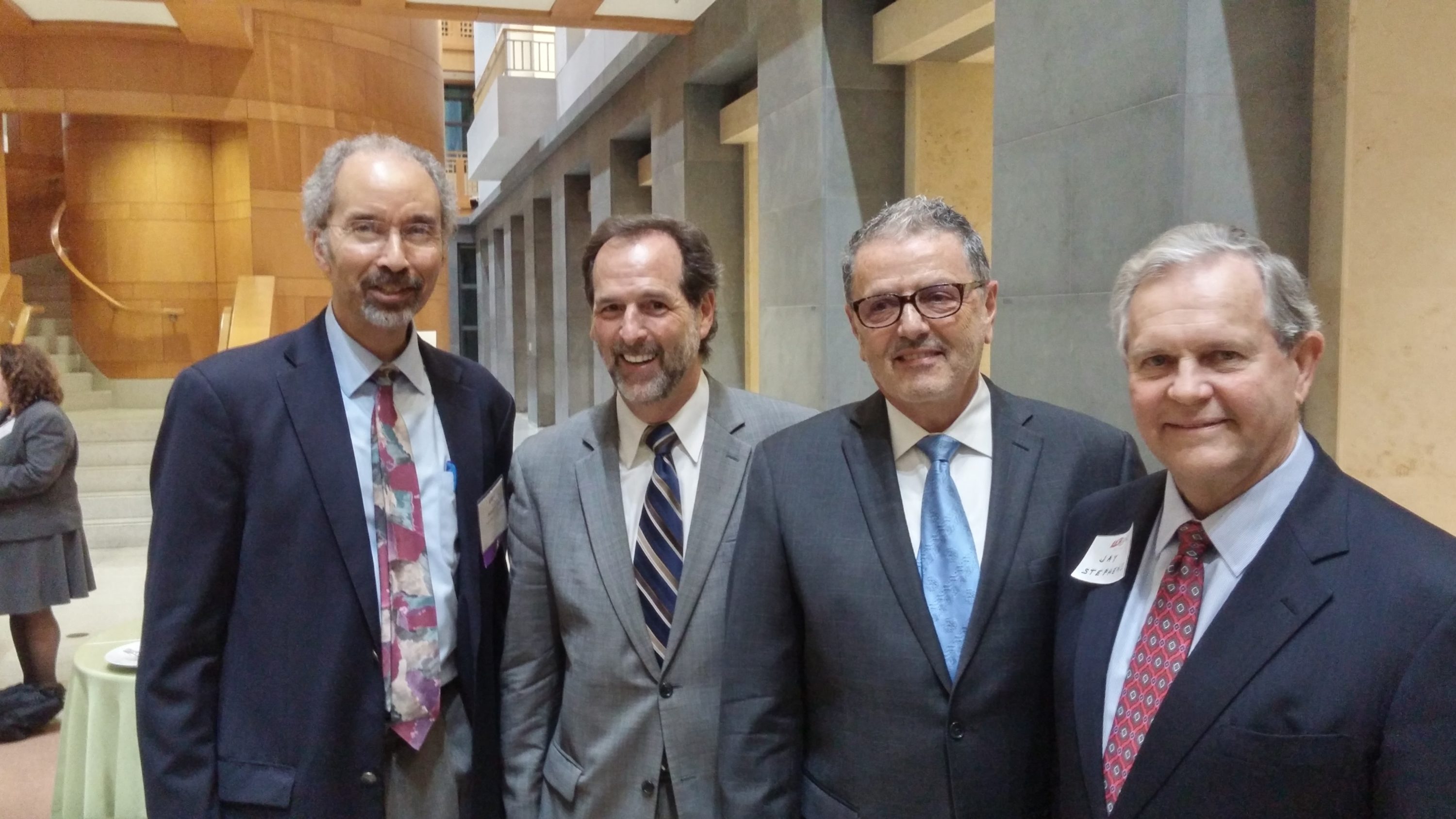 Roberts at a DC Bar reception this past spring, with, left to right, lawyers Howard Katzoff and Thomas Abbenante, and former DC US Attorney Jay Stephens. Photograph by Jeffery Leon, DC Bar. 