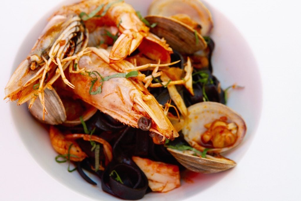 The kitchen offers plenty beyond pizza, like this squid ink pasta with seafood. 