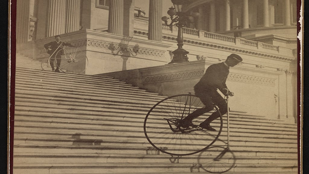 Man attempts to ride down the steps of the US Capitol Building Photograph by the Platt Brothers\ via Library of Congress.