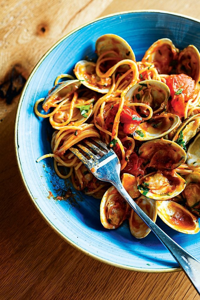 The thin strands of pasta are tossed with tomatoes and briny clams at Casolare. 