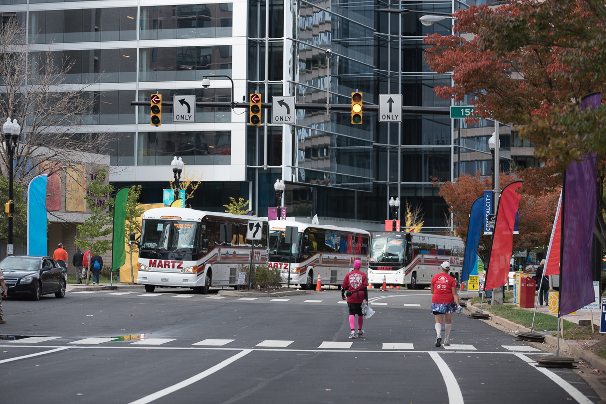 The four straggler buses that pick up the unlucky ones—those too slow to finish—wait at 15th Street and Crystal Drive in the Crystal City section of Arlington around mile 22. 