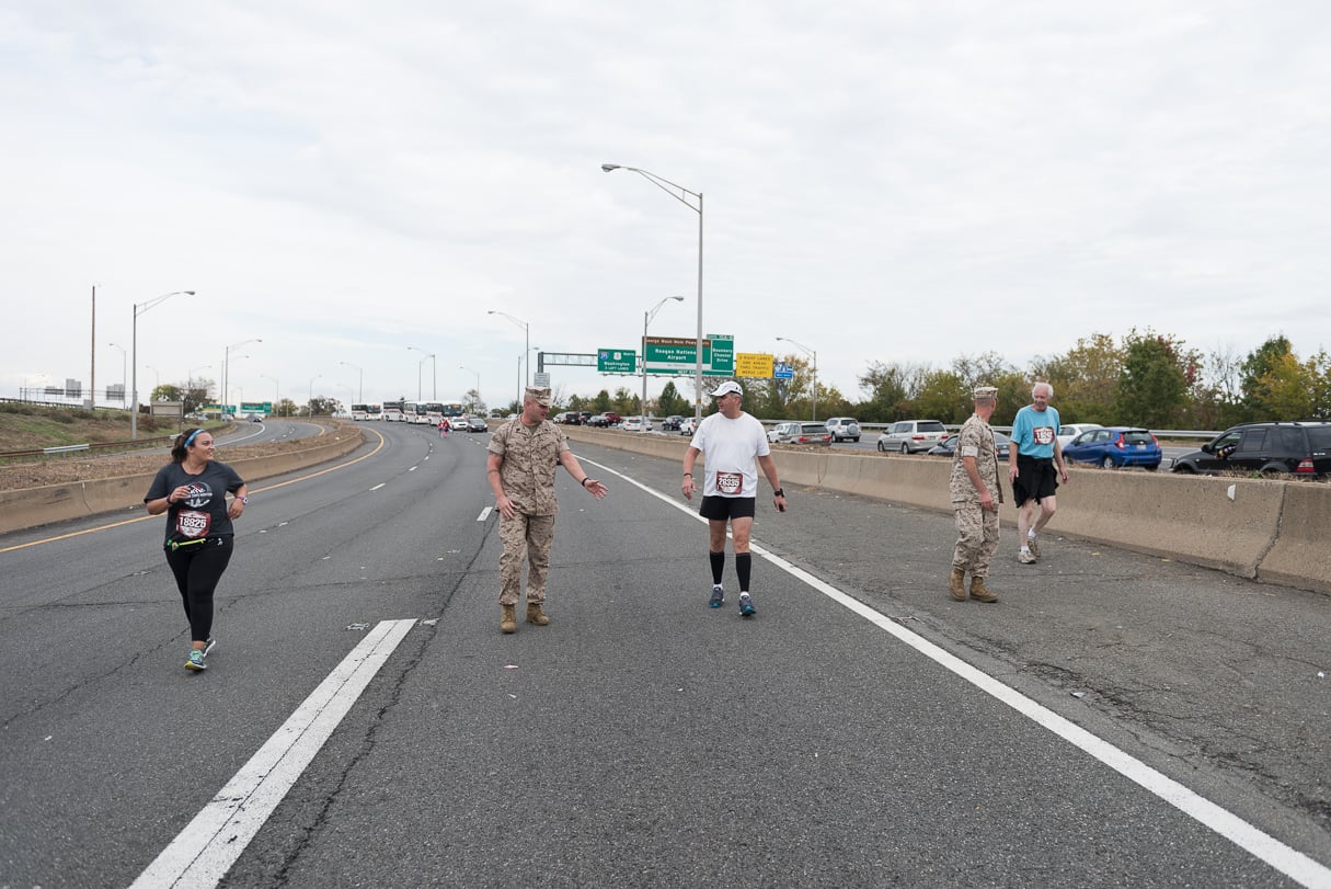 Marine Gunnery Sergeant Mark Bender is the guy who explained to runners gently, but firmly, their options for the rest of the afternoon: finishing along sidewalks after the roads open or riding the bus. 