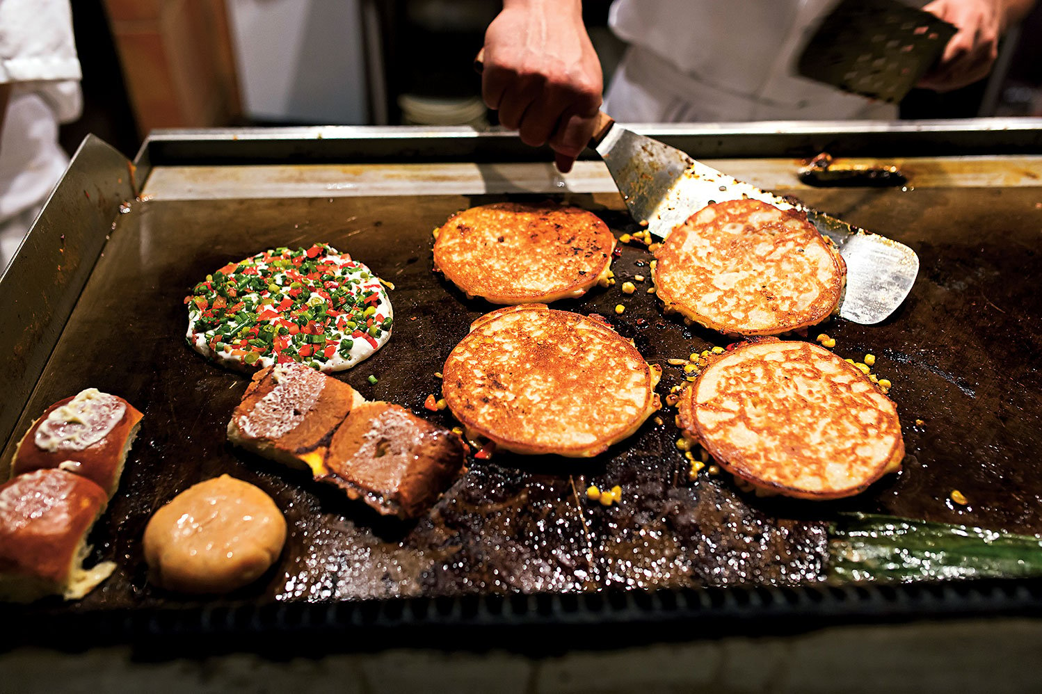 Uttapams on the griddle. Photo by Scott Suchman.